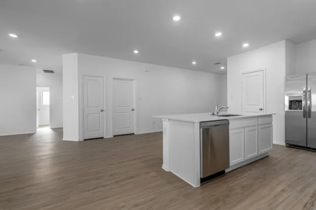 a kitchen with a refrigerator and a sink