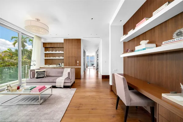 a living room with furniture and large window
