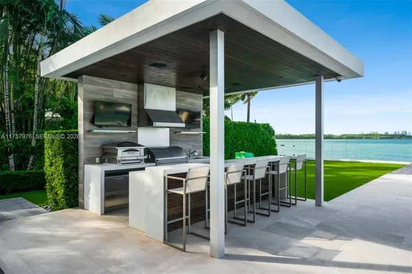 a patio with a table and chairs under an umbrella