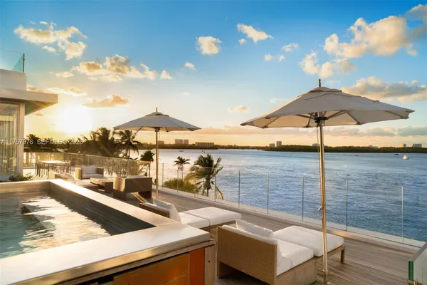 a view of a terrace with couches and sky view