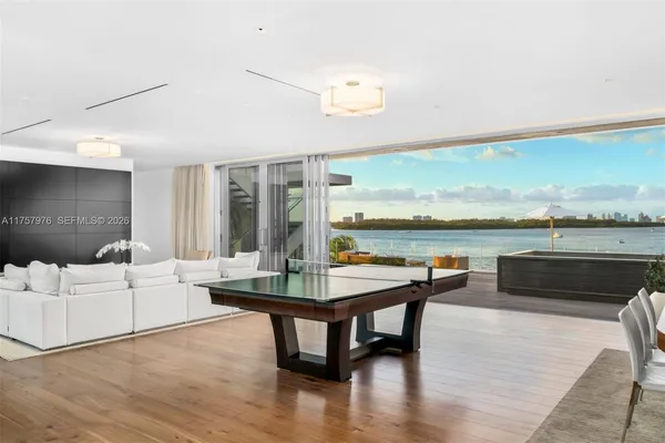 a living room with furniture and a floor to ceiling window
