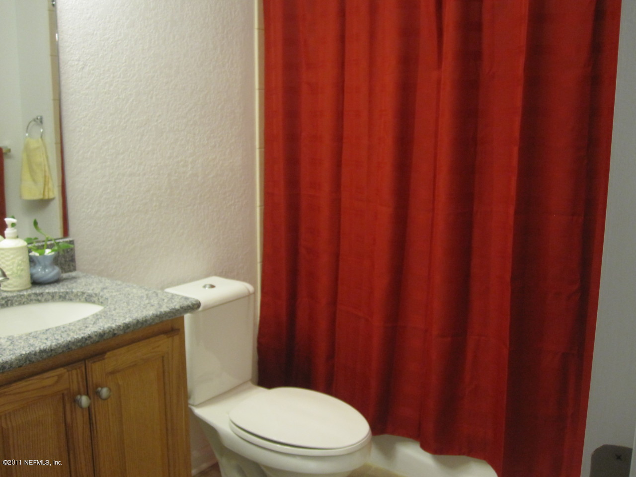12589 Knotah Road Jacksonville, FL 32258 - Photo 13 of 25 a bathroom with a granite countertop sink toilet and a mirror