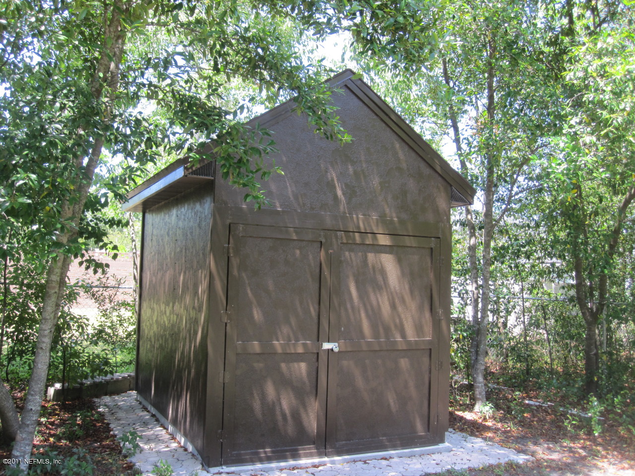 12589 Knotah Road Jacksonville, FL 32258 - Photo 15 of 25 a backyard of a house with lots of green space