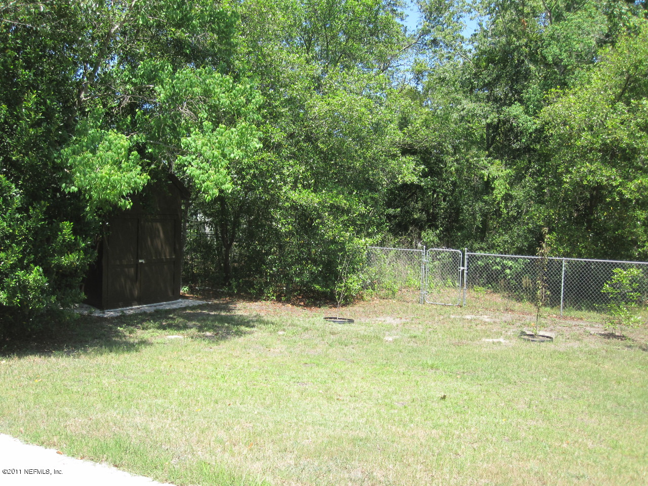 12589 Knotah Road Jacksonville, FL 32258 - Photo 19 of 25 a backyard of a house with lots of green space and fountain
