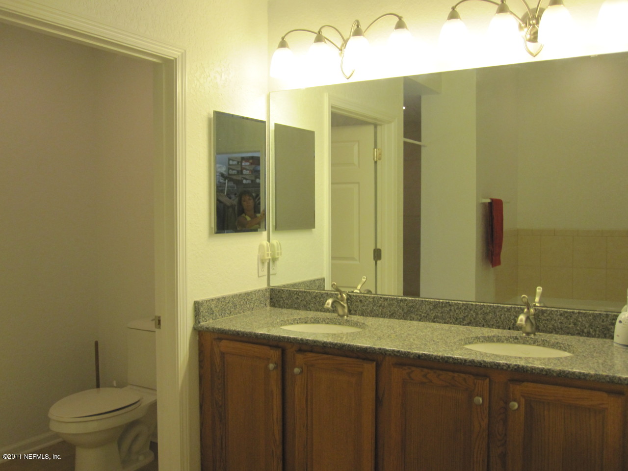 12589 Knotah Road Jacksonville, FL 32258 - Photo 5 of 25 a bathroom with a granite countertop sink and a mirror