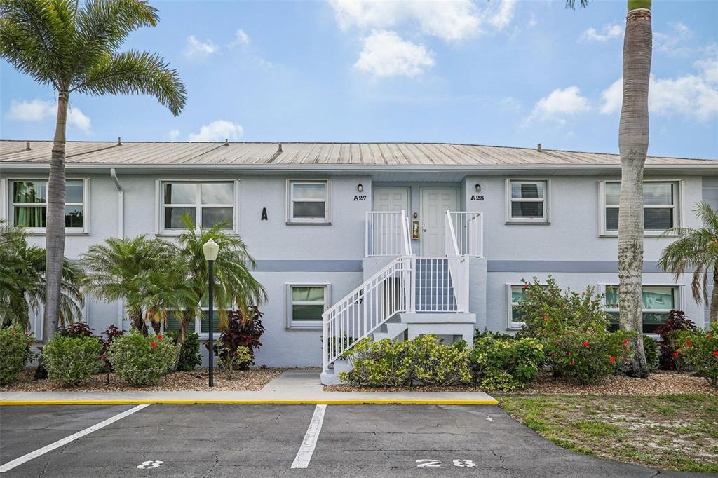 26485 Rampart Boulevard, Unit A27 Punta Gorda, FL 33983 - Photo 1 of 27 a front view of a house with a garden