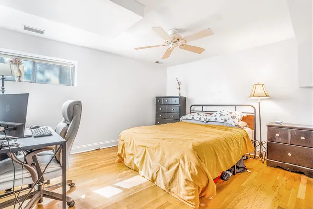 a bedroom with a bed and a desk