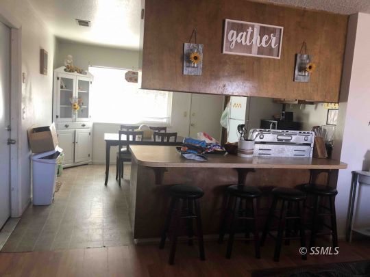 125 South Broadway Street Ridgecrest, CA 93555 - Photo 19 of 24 a kitchen with a table chairs and a stove