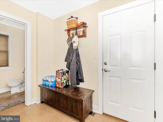 a view of a bedroom with wooden floor and a window