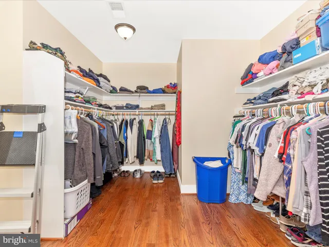 a view of a house with a yard and large tree