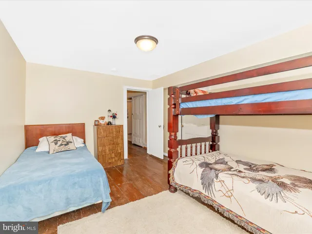 a view of a patio with couches and table and chairs with wooden floor
