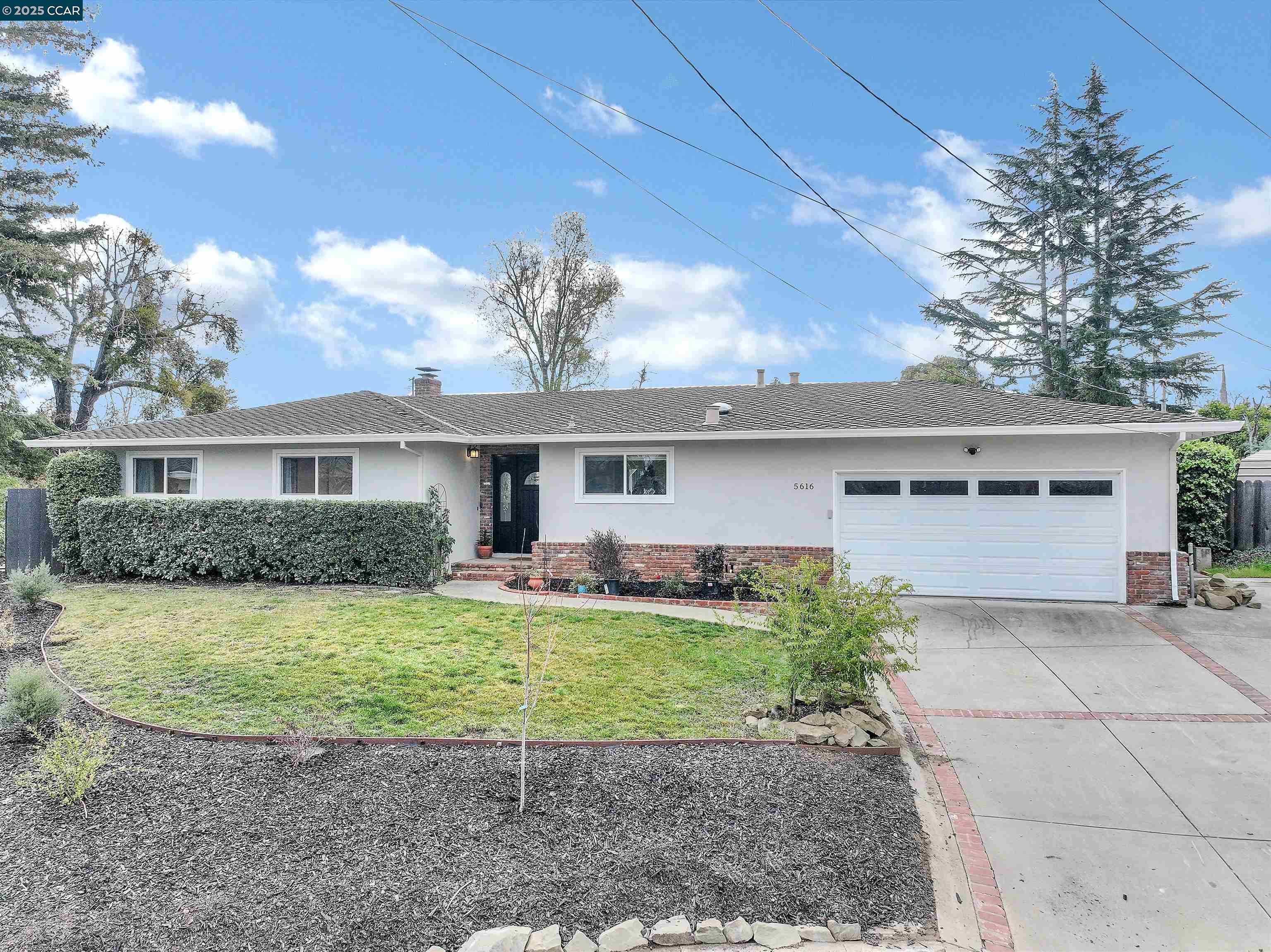 5616 Shasta Court Clayton, CA 94517 - Photo 1 of 49 a front view of a house with a yard and garage