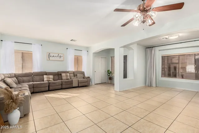 a living room with furniture and a chandelier