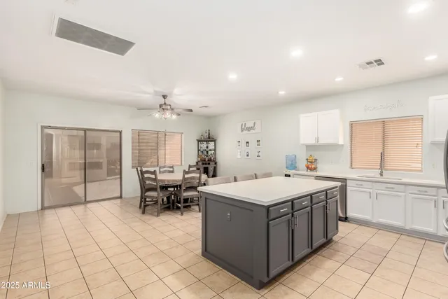 a large white kitchen with a large window