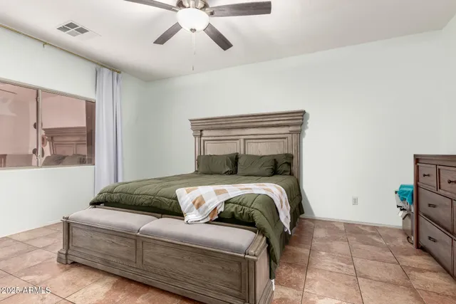 a bedroom with a bed and window