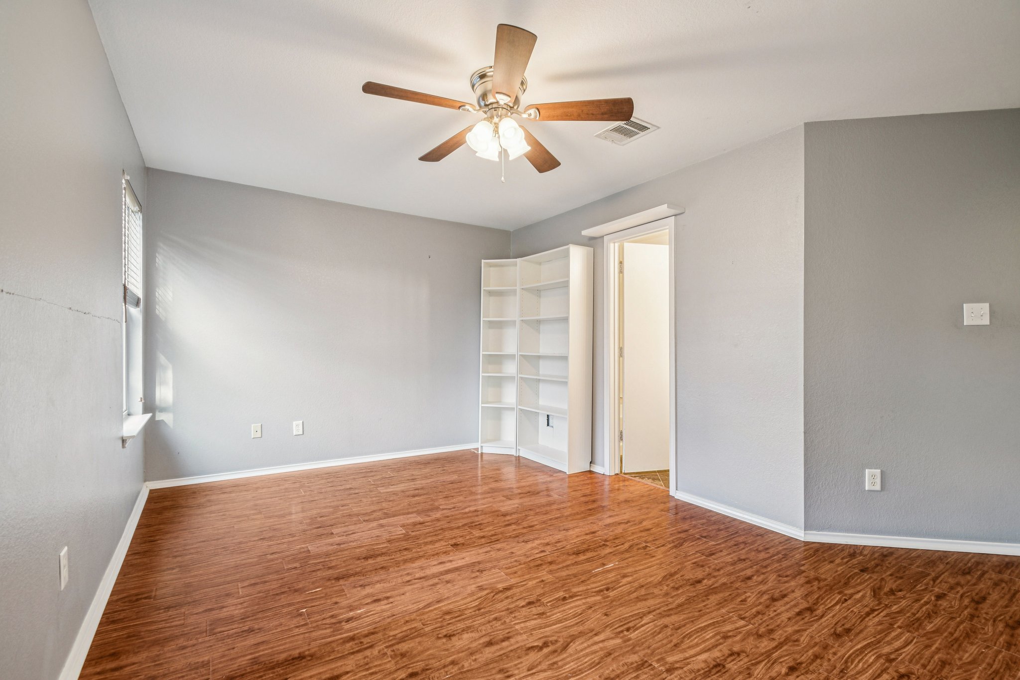 100 Kendall Cove Elgin, TX 78621 - Photo 16 of 31 a view of a room with a ceiling fan and a window