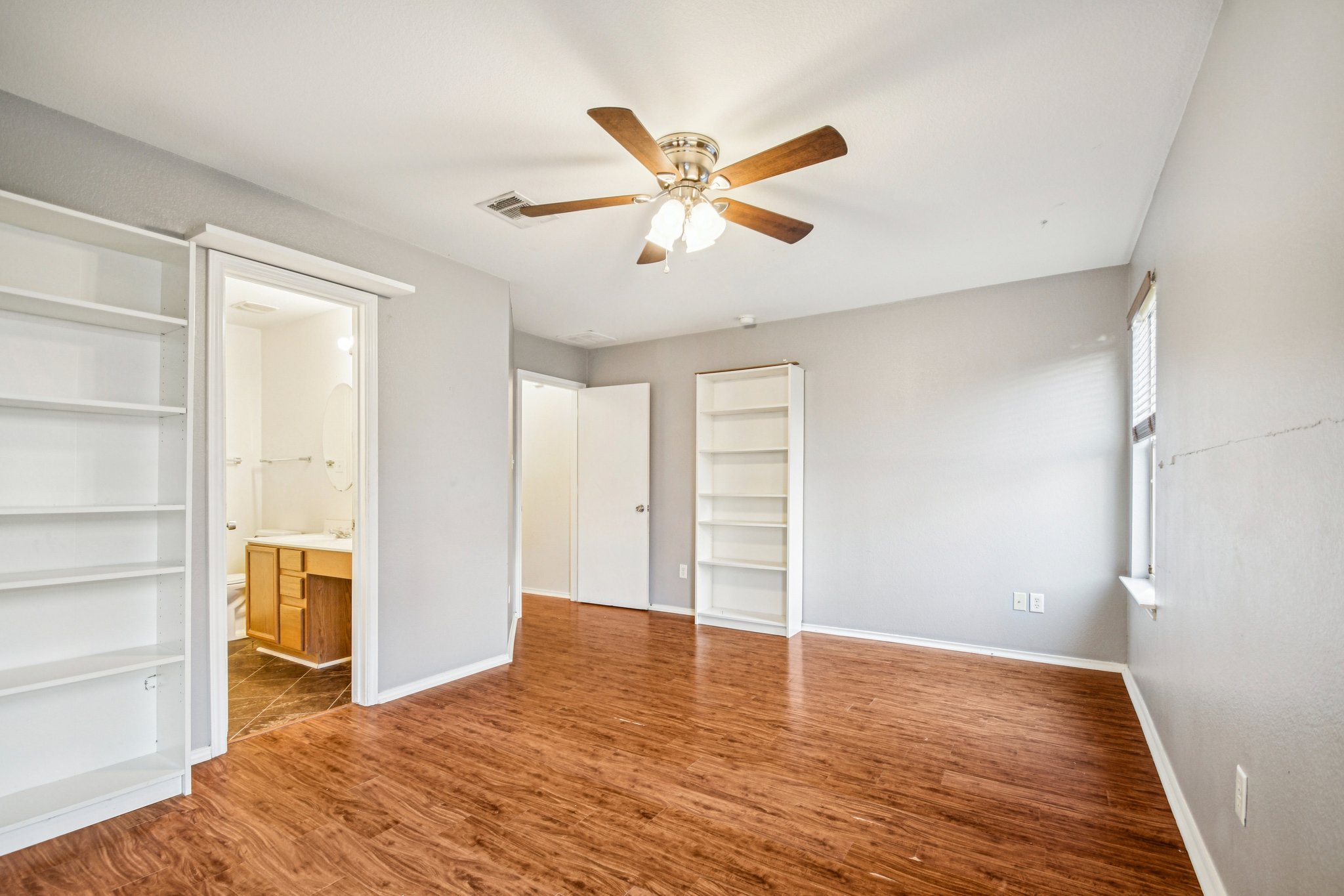 100 Kendall Cove Elgin, TX 78621 - Photo 17 of 31 a view of empty room with wooden floor and ceiling fan