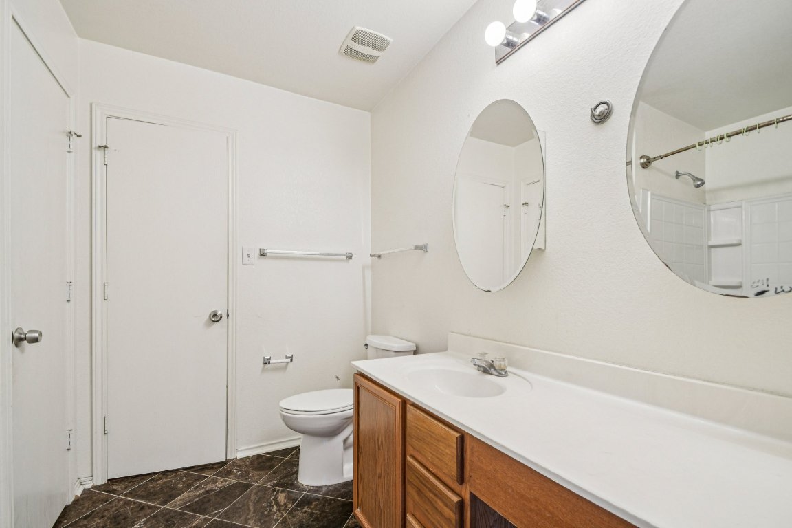 100 Kendall Cove Elgin, TX 78621 - Photo 18 of 31 a bathroom with a sink a toilet and a mirror