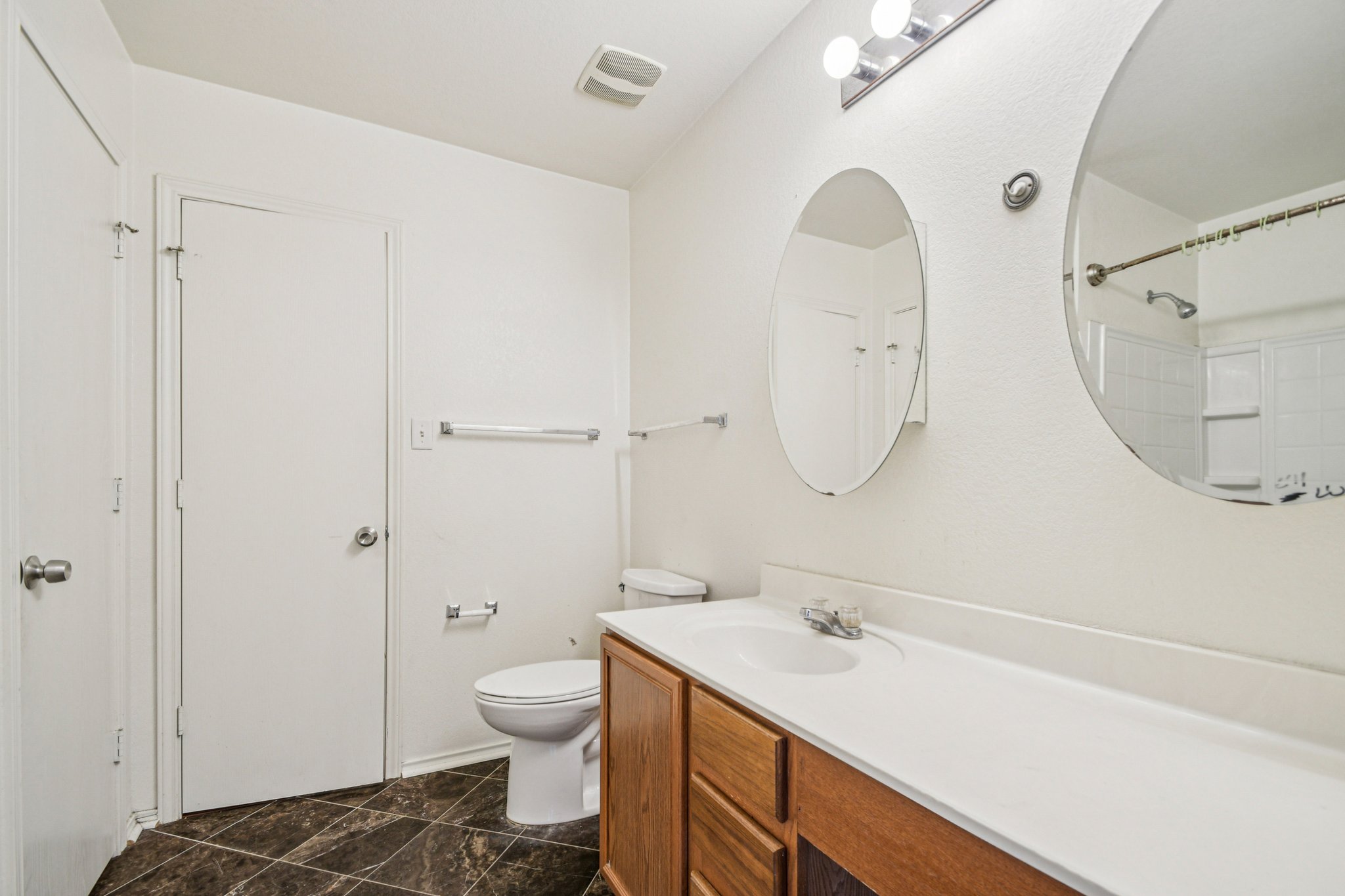 100 Kendall Cove Elgin, TX 78621 - Photo 18 of 31 a bathroom with a sink a toilet and a mirror