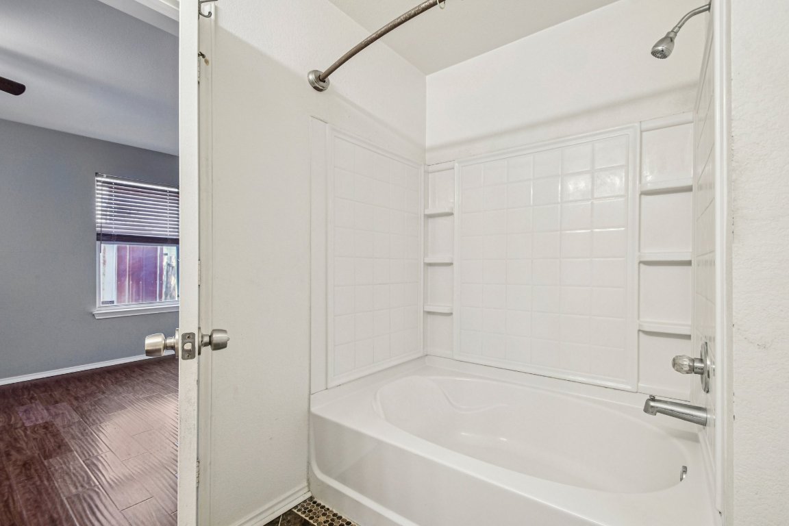 100 Kendall Cove Elgin, TX 78621 - Photo 19 of 31 a white bath tub sitting next to a white sink