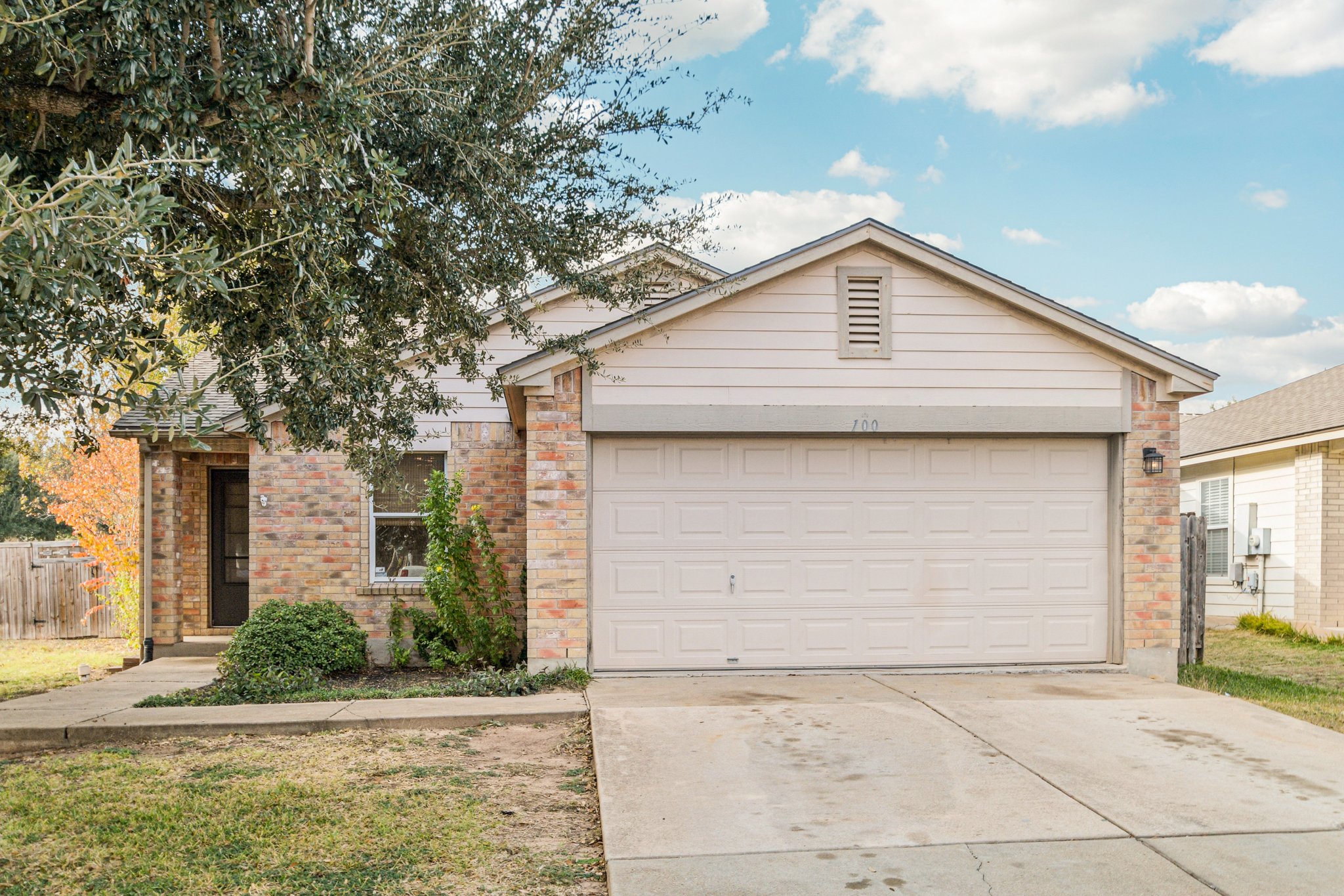 100 Kendall Cove Elgin, TX 78621 - Photo 4 of 31 a small white house with a white roof and front door