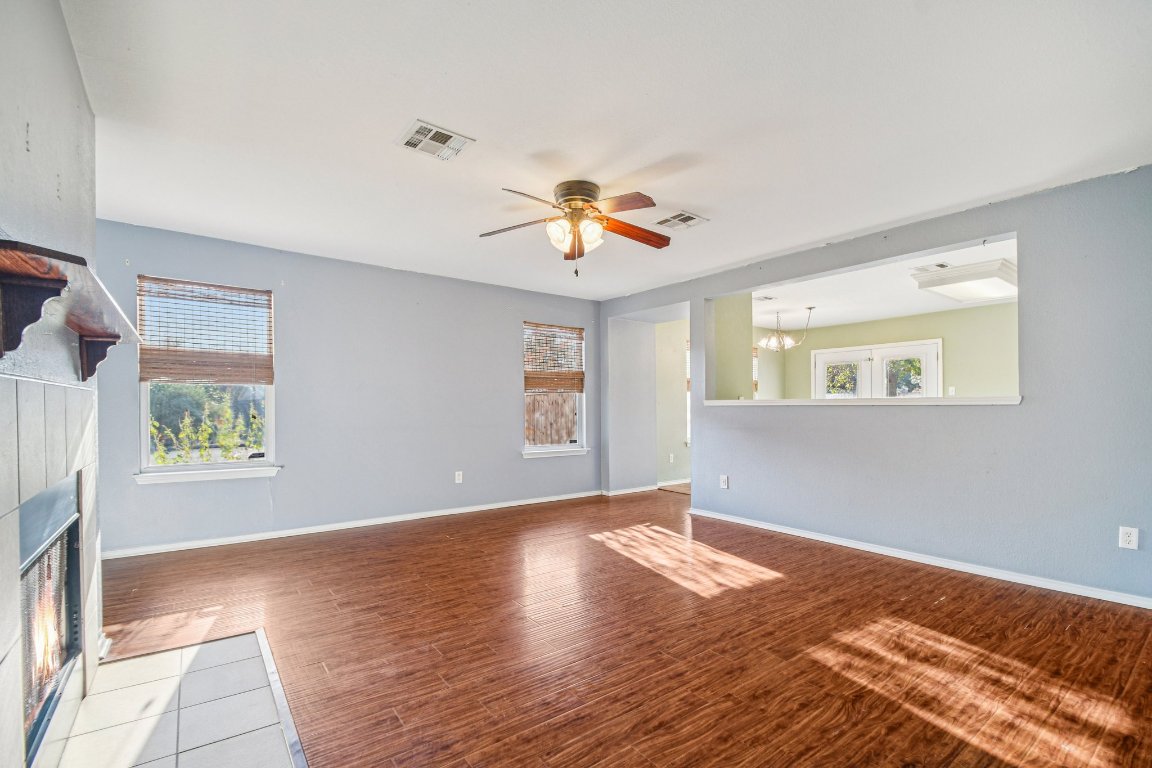 100 Kendall Cove Elgin, TX 78621 - Photo 6 of 31 a view of an empty room with window and wooden floor