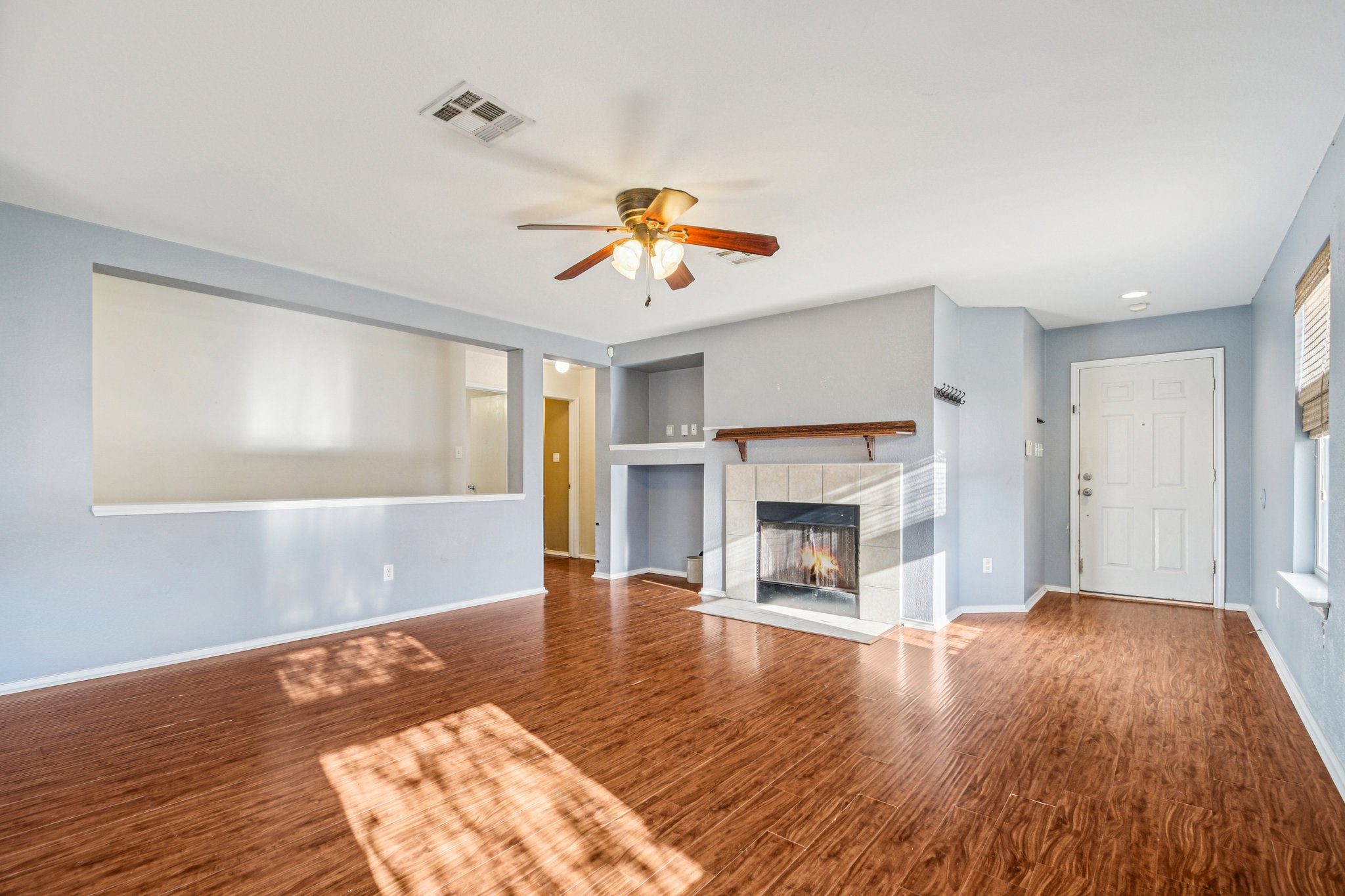 100 Kendall Cove Elgin, TX 78621 - Photo 7 of 31 a view of empty room with wooden floor and fireplace