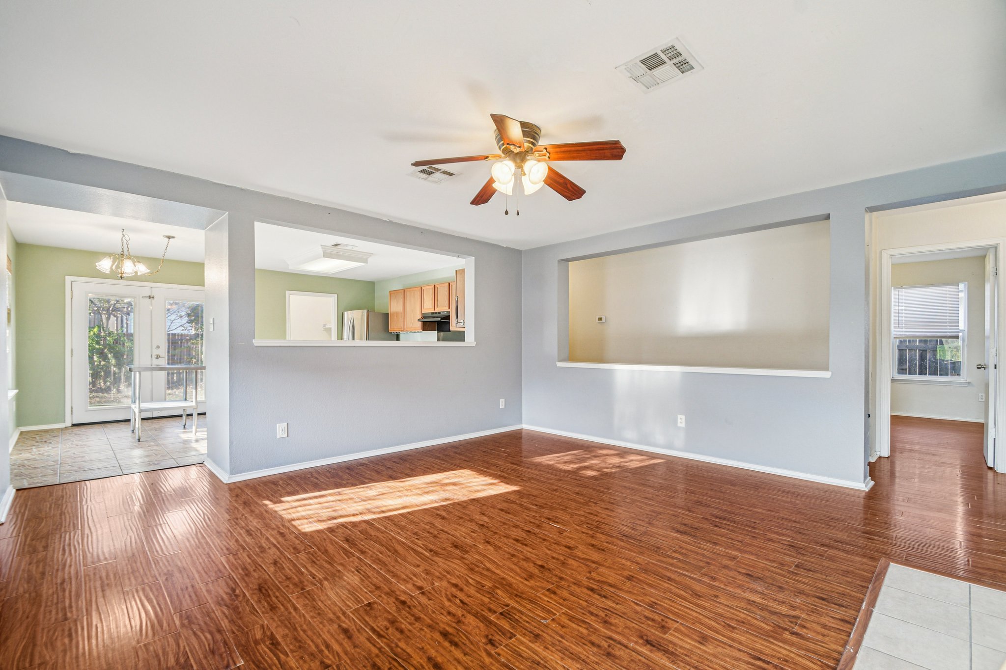 100 Kendall Cove Elgin, TX 78621 - Photo 8 of 31 an empty room with wooden floor and windows
