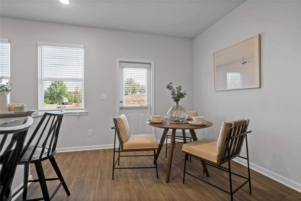 10 American Avenue, Unit ANISE Newnan, GA 30263 - Photo 12 of 47 a view of a dining room with furniture window and wooden floor