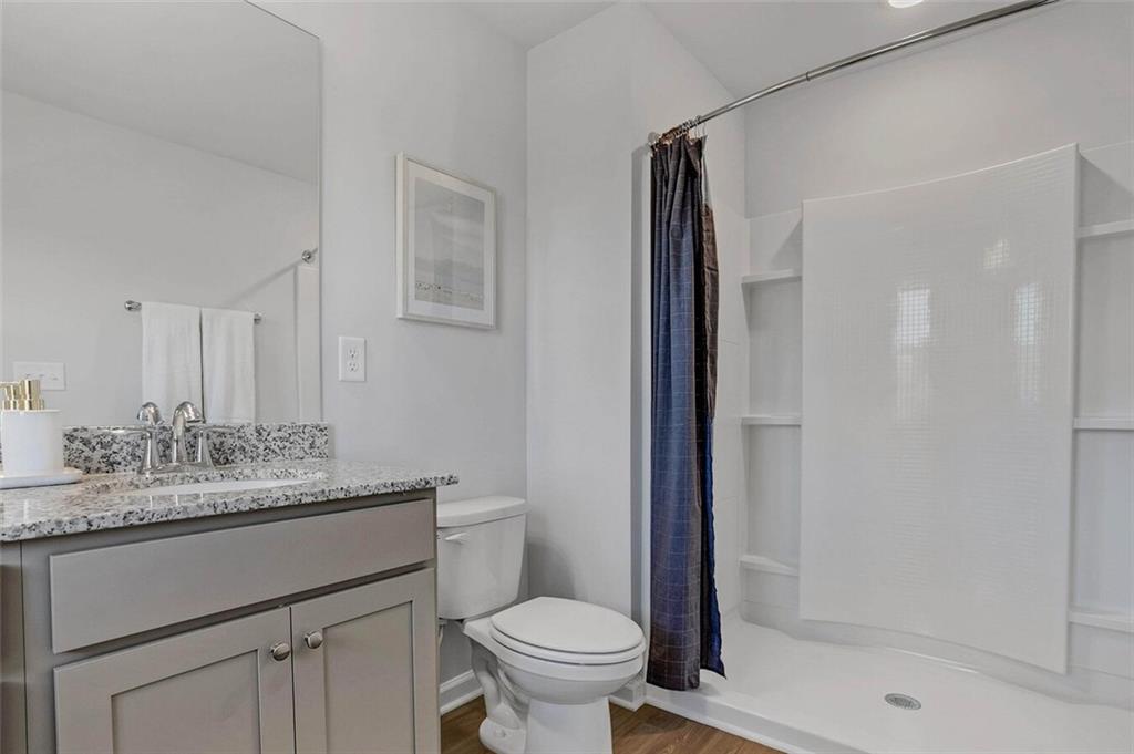 10 American Avenue, Unit ANISE Newnan, GA 30263 - Photo 27 of 47 a bathroom with a granite countertop sink toilet and shower
