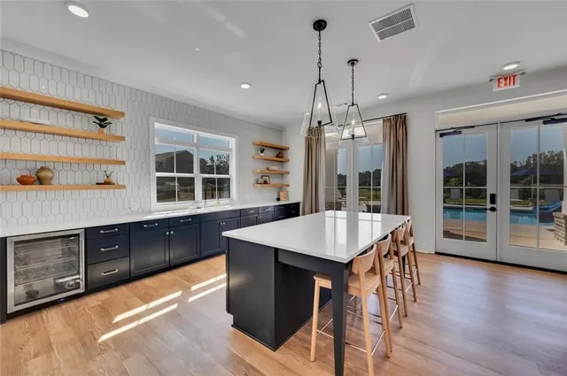 a patio with swimming pool table and chairs