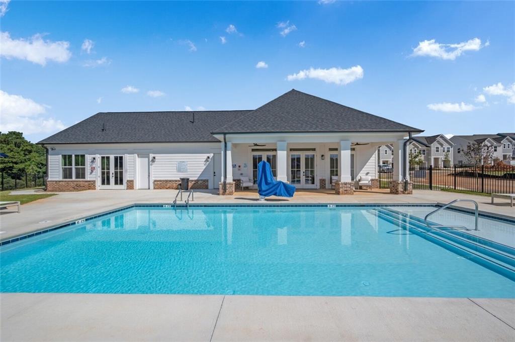 10 American Avenue, Unit ANISE Newnan, GA 30263 - Photo 35 of 47 a view of house with swimming pool and a outdoor seating