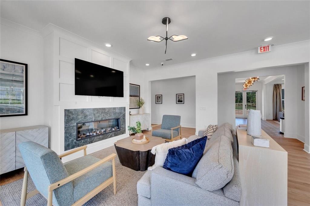 10 American Avenue, Unit ANISE Newnan, GA 30263 - Photo 40 of 47 a living room with furniture a fireplace and a flat screen tv