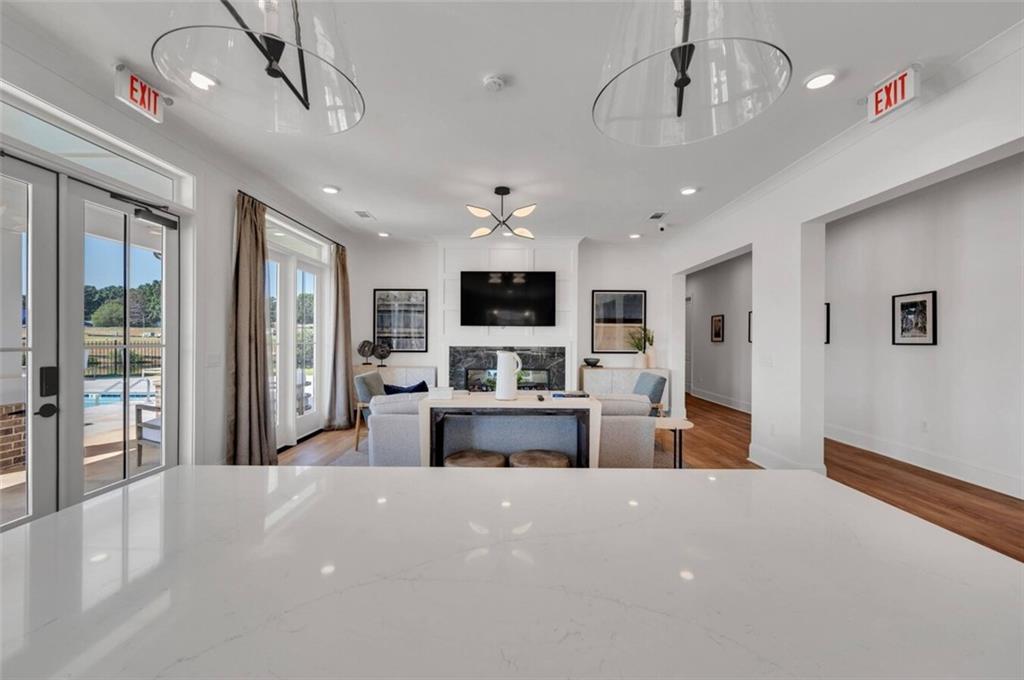 10 American Avenue, Unit ANISE Newnan, GA 30263 - Photo 45 of 47 a large living room with stainless steel appliances furniture or chandelier and a kitchen view