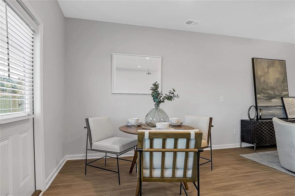 10 American Avenue, Unit ANISE Newnan, GA 30263 - Photo 5 of 47 a dining room with furniture and wooden floor