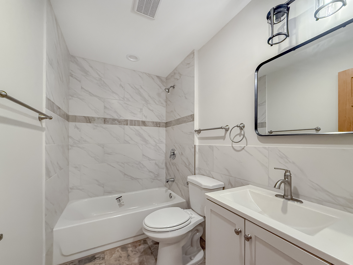 6415 West Irving Park Road, Unit 2N Chicago, IL 60634 - Photo 12 of 16 a bathroom with a sink toilet and shower