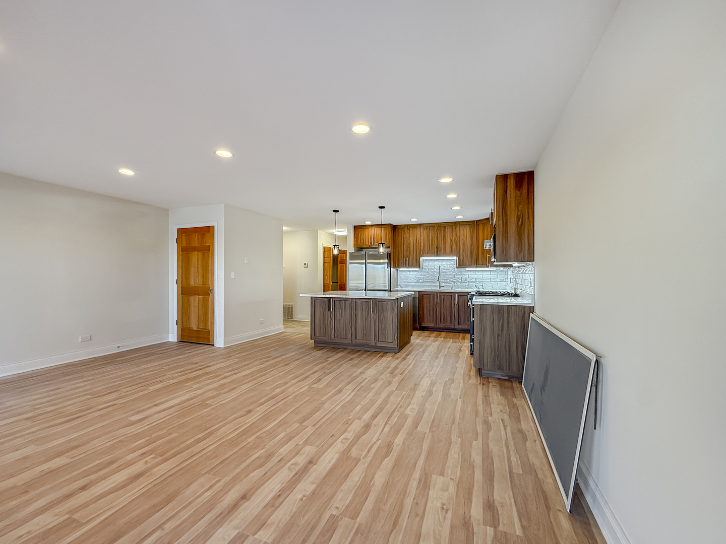 6415 West Irving Park Road, Unit 2N Chicago, IL 60634 - Photo 7 of 16 a view of kitchen and kitchen with wooden floor