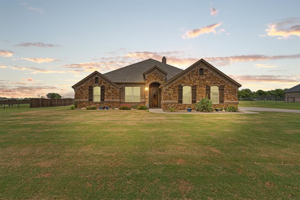 9708 Puma Trail Godley, TX 76044 - Photo 1 of 40 a front view of a house with a garden