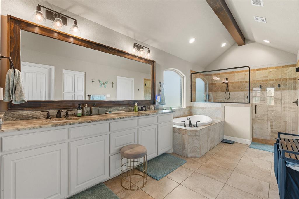 9708 Puma Trail Godley, TX 76044 - Photo 15 of 40 a bathroom with a granite countertop sink a toilet a mirror and bathtub