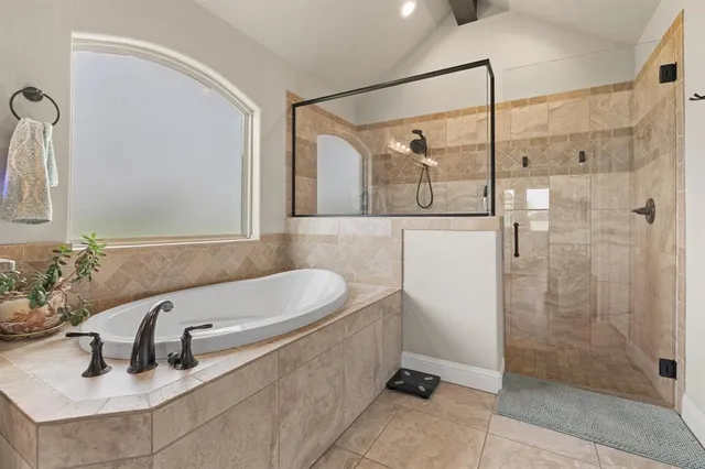 a bathroom with a granite countertop sink a toilet a mirror and bathtub