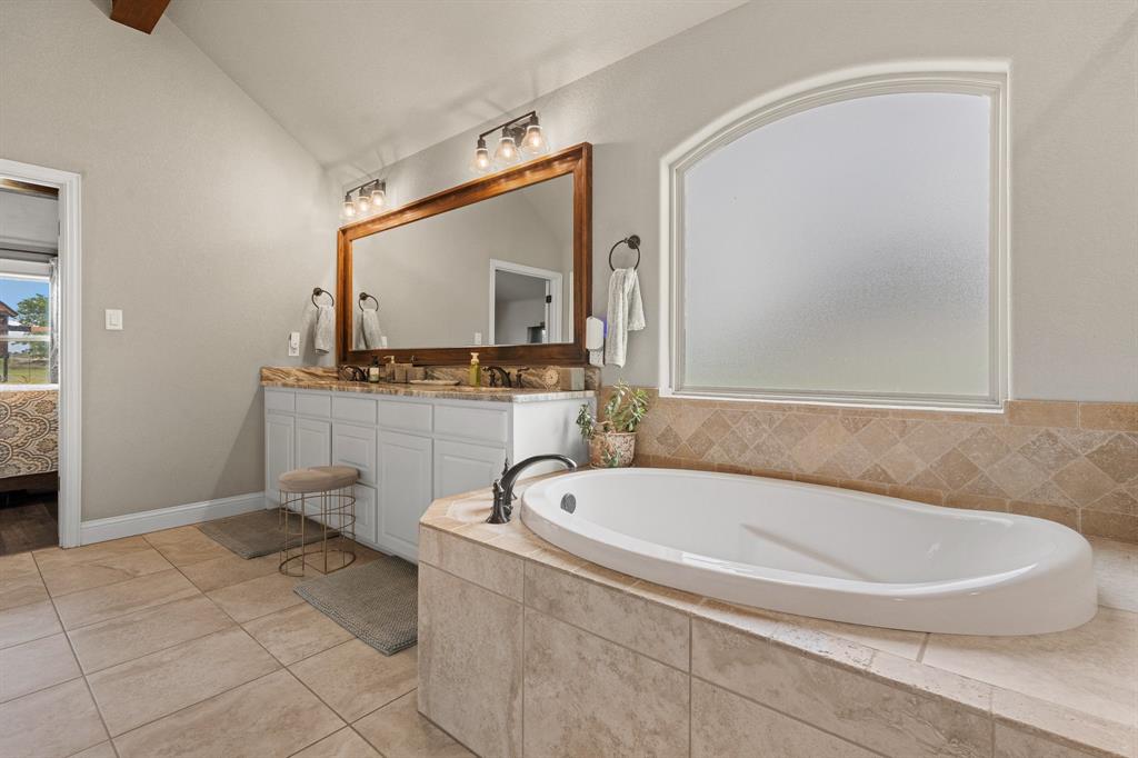 9708 Puma Trail Godley, TX 76044 - Photo 17 of 40 a white bath tub sitting in a bathroom