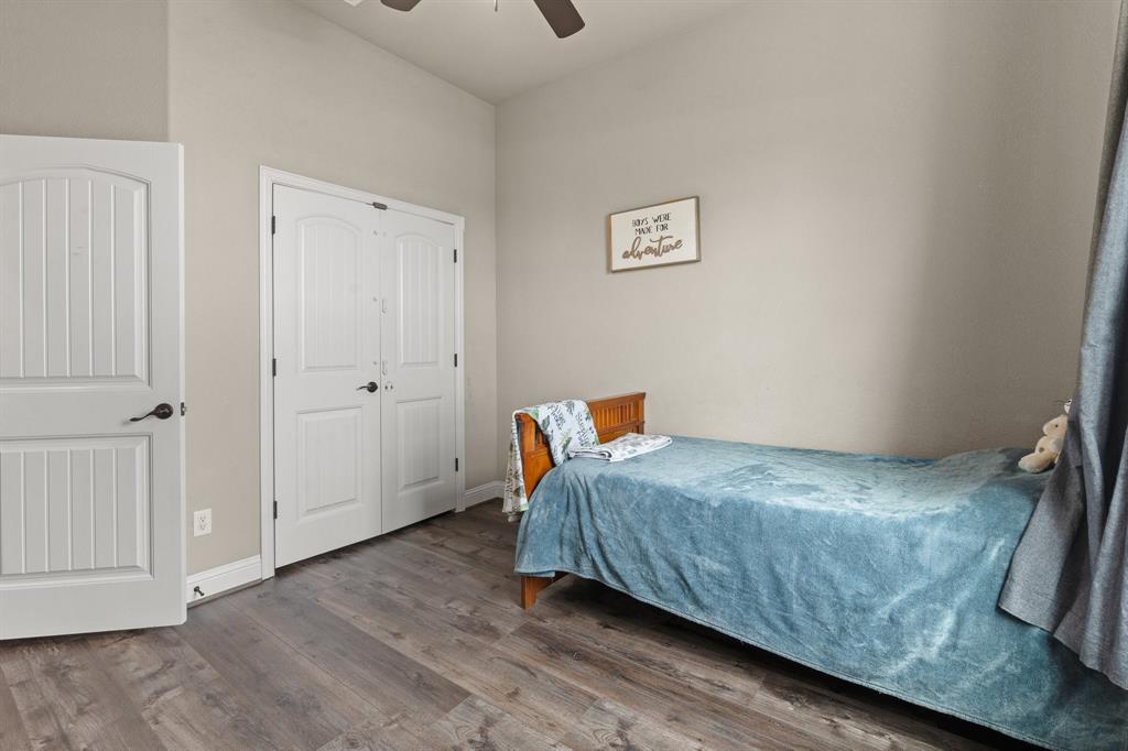 9708 Puma Trail Godley, TX 76044 - Photo 22 of 40 a bedroom with a bed and wooden floor
