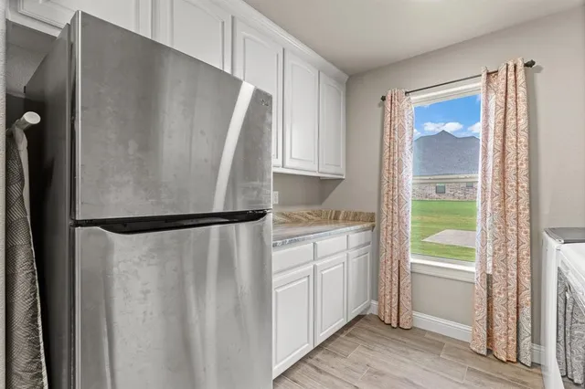 a view of a kitchen with sink and cabinets