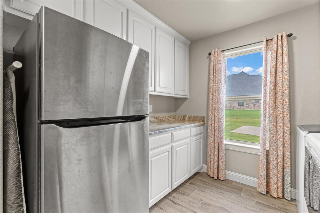 9708 Puma Trail Godley, TX 76044 - Photo 27 of 40 a white refrigerator freezer sitting inside of a kitchen