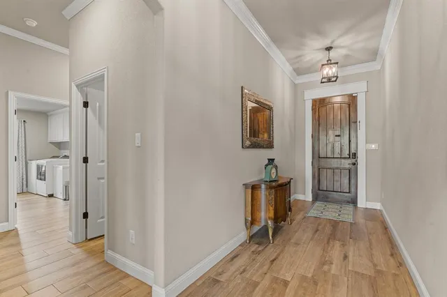 a view of a hallway view with wooden floor and staircase