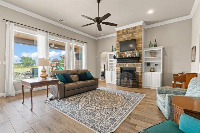 a living room with furniture a fireplace and a table
