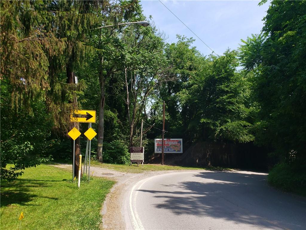 1439 Sharon Road New Brighton, PA 15066 - Photo 4 of 33 a street sign on a sidewalk next to a road