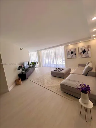 a living room with furniture and a mirror