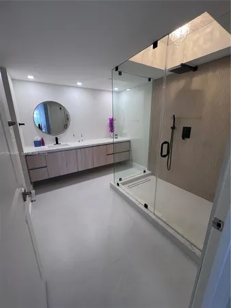 a bathroom with a tub sink and mirror