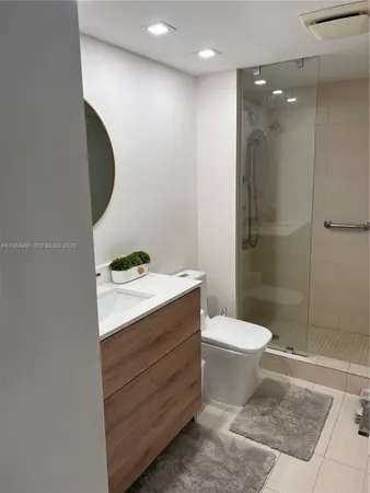 a bathroom with a sink toilet and shower
